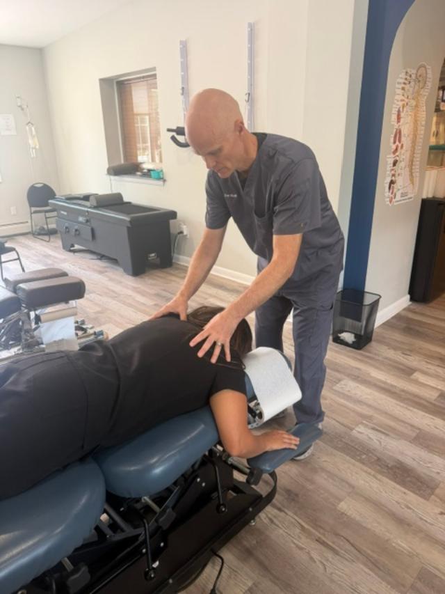 Dr. Dan Klein evaluating a patient with neck pain and arm symptoms in Upper Darby PA