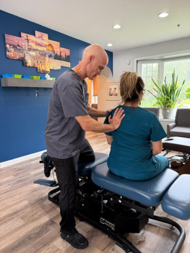 Dr. Dan Klein evaluando dolor de hombro en un paciente en Upper Darby